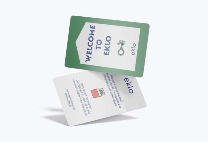 Two “Welcome to Eklo” hotel key cards floating against a pale background, showing the front and back designs.